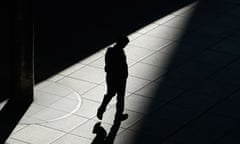 A man walks on a footbridge