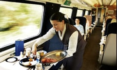 Food being served in a first-class train carriage.
