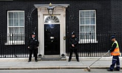 A council worker sweeps Downing Street