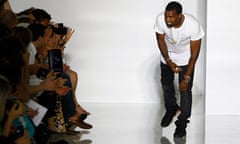 Kanye West acknowledges applause at the end of his Spring/Summer 2012 show at Paris Fashion Week