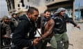 Rebel fighters carry a wounded comrade in Misrata, Libya