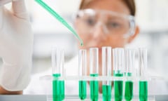 Scientist filling test tubes with pipette in laboratory