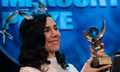 PJ Harvey smiles as she receives the 2011 Mercury Prize in London