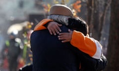 A boy embraces his dad