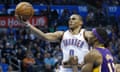 Oklahoma City Thunder guard Russell Westbrook (0) shoots in front of Los Angeles Lakers center Dwight Howard (12) in the third quarter of an NBA basketball game in Oklahoma City, Friday, Dec. 7, 2012. Oklahoma City won 114-108.(AP Photo/Sue Ogrocki)