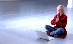 young woman sitting on floor with computer