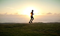 A silhouette of a jogger running alone with sun on horizon. Image shot 2010. Exact date unknown.