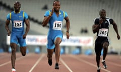 Asafa Powell (C) of Jamaica makes a worl