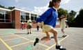 Schoolgirls skipping in a primary school playground in the UK