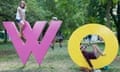 Kids climb on the Womad sign in the arboretum