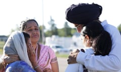 Mourners cry outside the scene of a mass shooting in Oak Creek, Wisconsin
