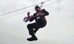 London Mayor Boris Johnson dangles in the air after getting stranded on a zip wire at Victoria Park