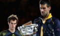 Andy Murray watches Novak Djokovic pick up the trophy.