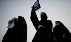 Bahraini Shia Muslim women hold up portraits of relatives being held in Bahraini jails during a demonstration in solidarity with human rights activists and political prisoners in the village of Sanabis, west of Manama, on 6 January 2013.