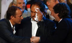 Martin Insaurralde, left, the lower house candidate of the ruling party, shakes hands with vice-president Amado Boudou as the votes come in, while Buenos Aires province governor Daniel Scioli wipes his forehead.