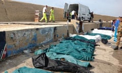 Bodies of drowned migrants are lined up in the port of Lampedusa