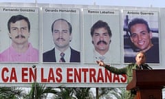 Castro delivers a speech in front of a poster of four of the 'Cuba five' at a Havana rally in 2003