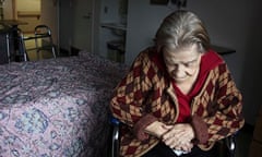 Elderly woman sits in her room at a nursing home