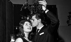 Actress Rosemary Lane and singer Ronnie Carroll kissing under the mistletoe