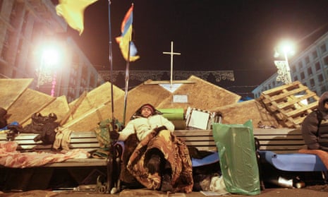 A Ukrainian protester rests on a bench at Independence Square in Kiev