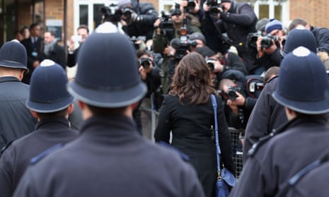 Nigella Lawson is escorted with policemen as she arrives at Isleworth Crown Court.