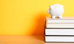 A piggy bank on top of a stack of books