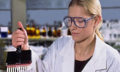 Technician filling test tubes
female woman scientist