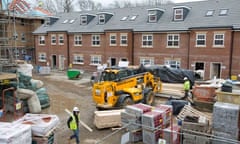 Construction workers build a new residential property development in north London