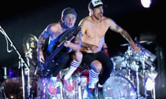 Flea and Anthony Kiedis of Red Hot Chili Peppers leap while on stage at the Empire Polo Club for Coachella on 14 April