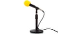 Microphone on a small black stand with a yellow cover