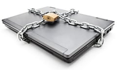 Heavy chain with a padlock around a laptop