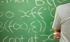 Student Working Out Math Equation on Blackboard