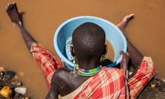 A Toposa girl pans for gold in the Singaita River in Namorinyang, South Sudan