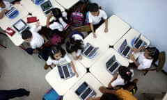 children follow a lesson on their laptops 