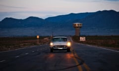 A 1957 Ford Thunderbird driving at dusk in Mesa Del Sol desert, Albuquerque, New Mexico, United States.
