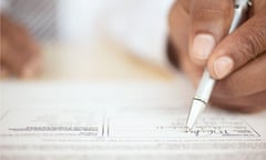 Man's hand signing a contract