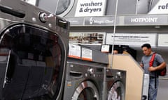 Shoppers look at washers and dryers at a Home Depot store in New York