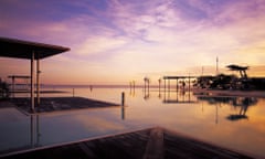 Cairns esplanade public swimming lagoon at sunset, Australia.