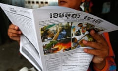 A man reads newspaper coverage about the elections