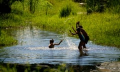 Children cool off in the river at Sutter Creek, California.