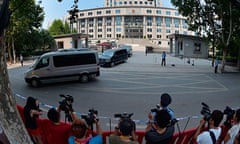 Press photographers take pictures of the convoy ferrying Bo Xilai from the Jinan courtroom