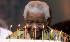 Nelson Mandela blows out candles on a cake at the Loftus stadium in Pretoria