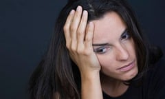 Young depressed woman on black background