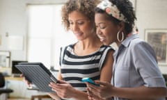 African American women using a tablet and smartphone