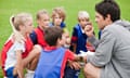 Football coach talking to his young team 