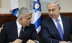 Israel's finance minister Yair Lapid, left, and prime minister Benjamin Netanyahu attend a cabinet meeting in Jerusalem.