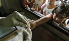 A girl is tested for malaria in Thailand. 