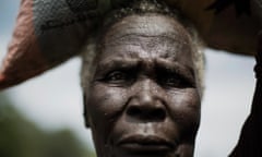 Achol Akuei is on her way to the market in Calek to sell sorghum to raise money for her grandchild s medicines in the buffer zone of Northern Bahr el Ghazal, South Sudan, October 15, 2014. Her grandchild, five-year-old Angui, suffers from malaria and is very ill.