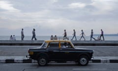 A driver waits for customers in his Premier Padmini taxi on Marine Drive in Mumbai.