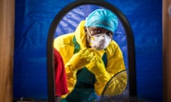 A health worker dons protective gear before entering an Ebola treatment centre in Freetown, Sierra Leone.